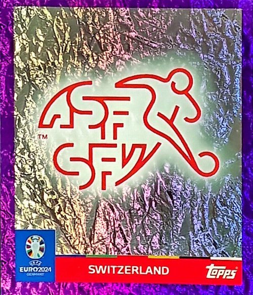 Topps - UEFA Germany Euro 2024 Αυτοκόλλητο - SUI 1.
Logo (Switzerland) - Purple Parallel Foil